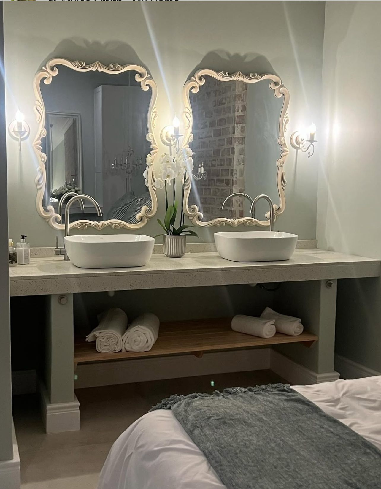 Twin vessel basins with ornate baroque mirrors
