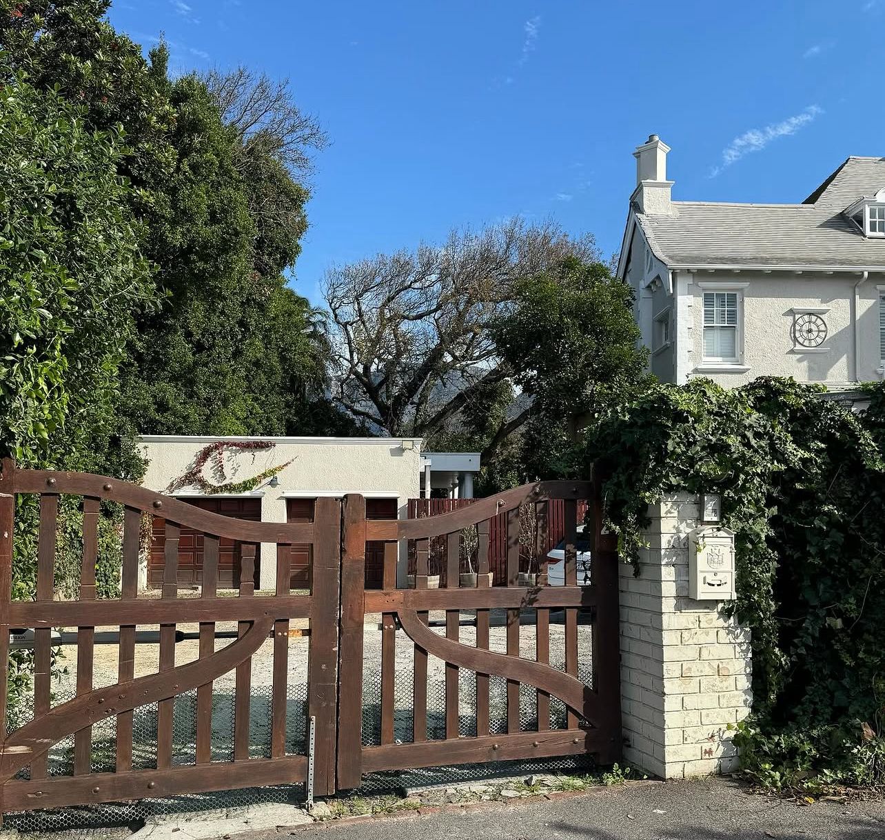 Wooden entrance gate framed by climbing ivy