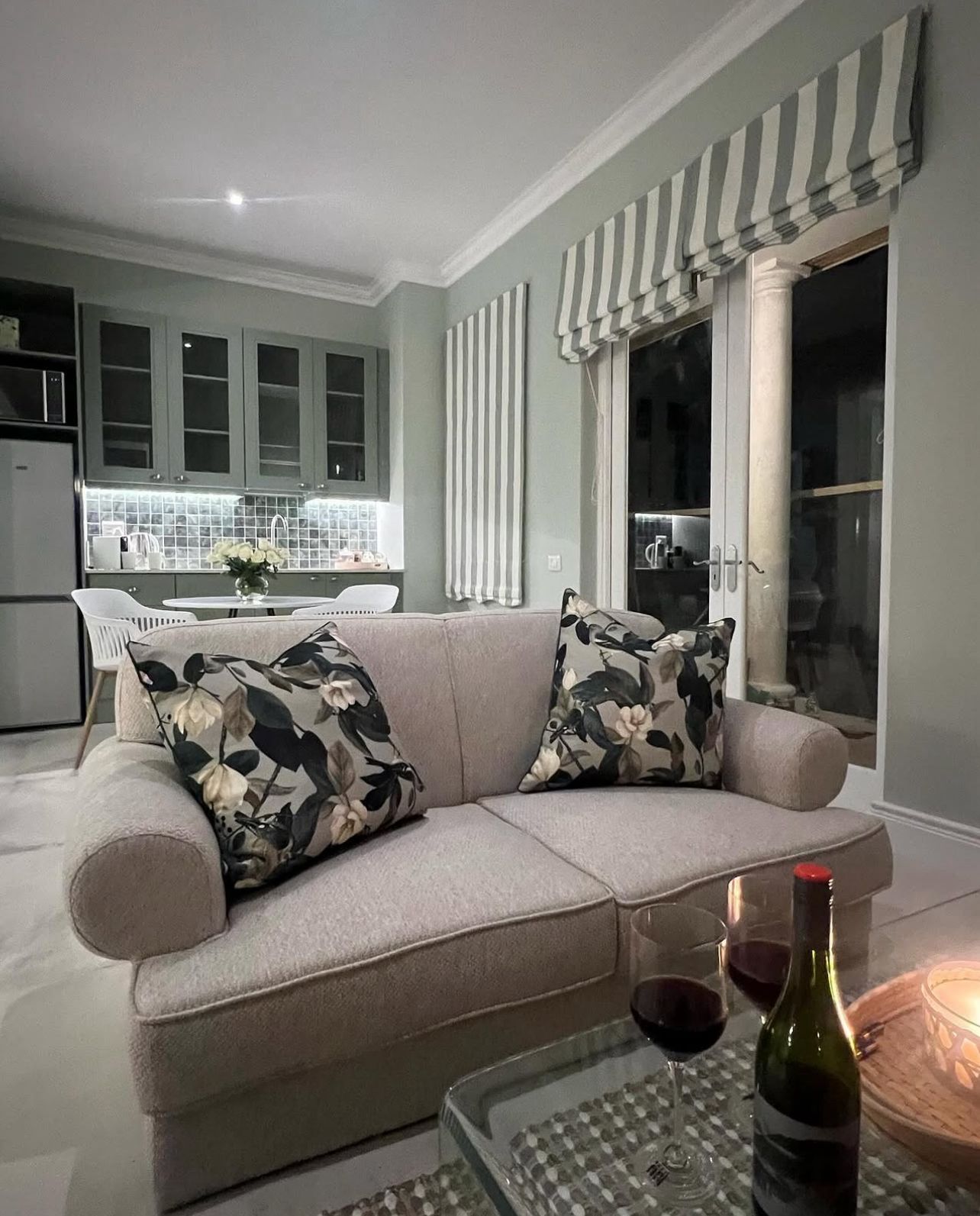 Boutique lounge with floral cushions and wine