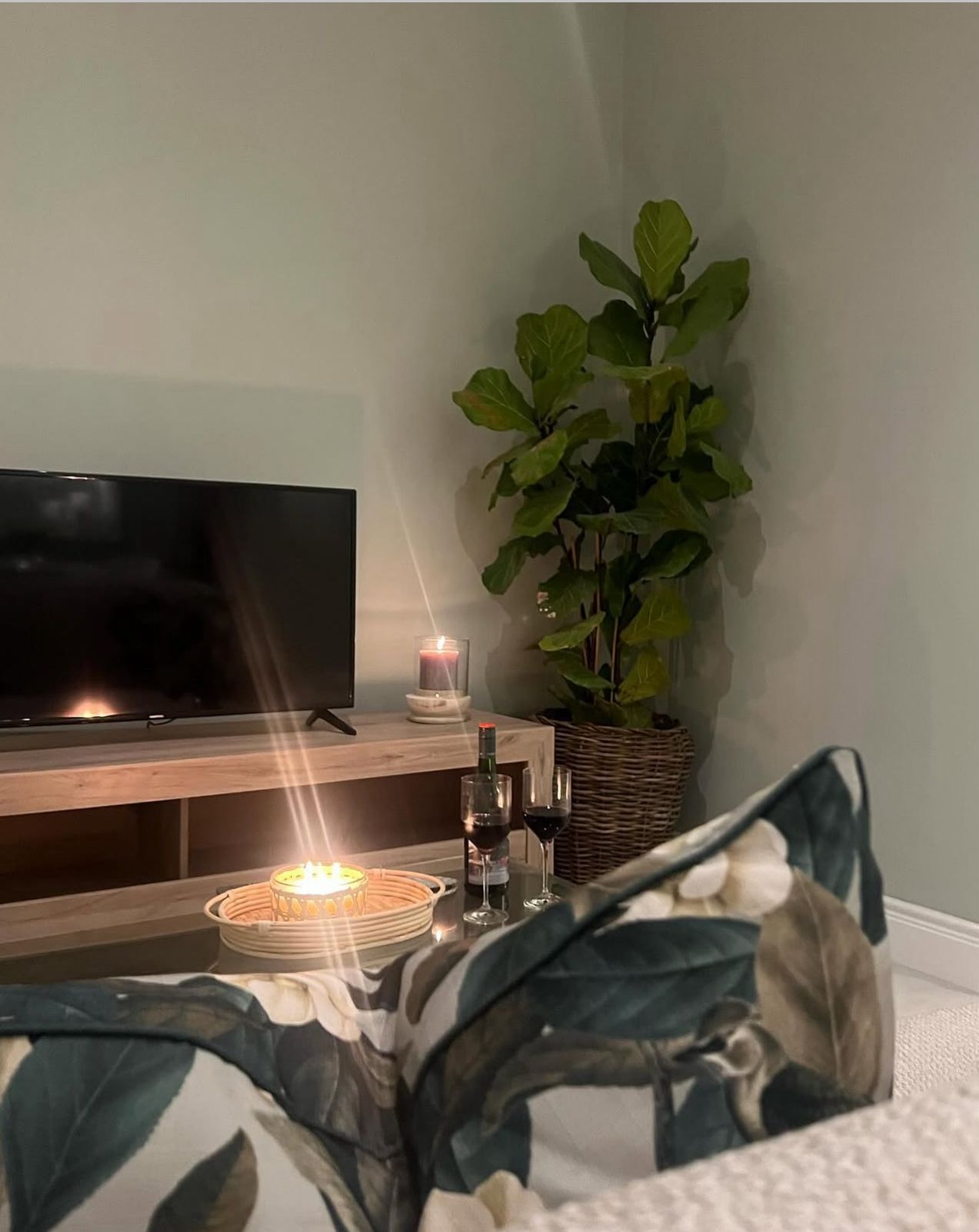 Candlelit corner with fiddle leaf fig and wine