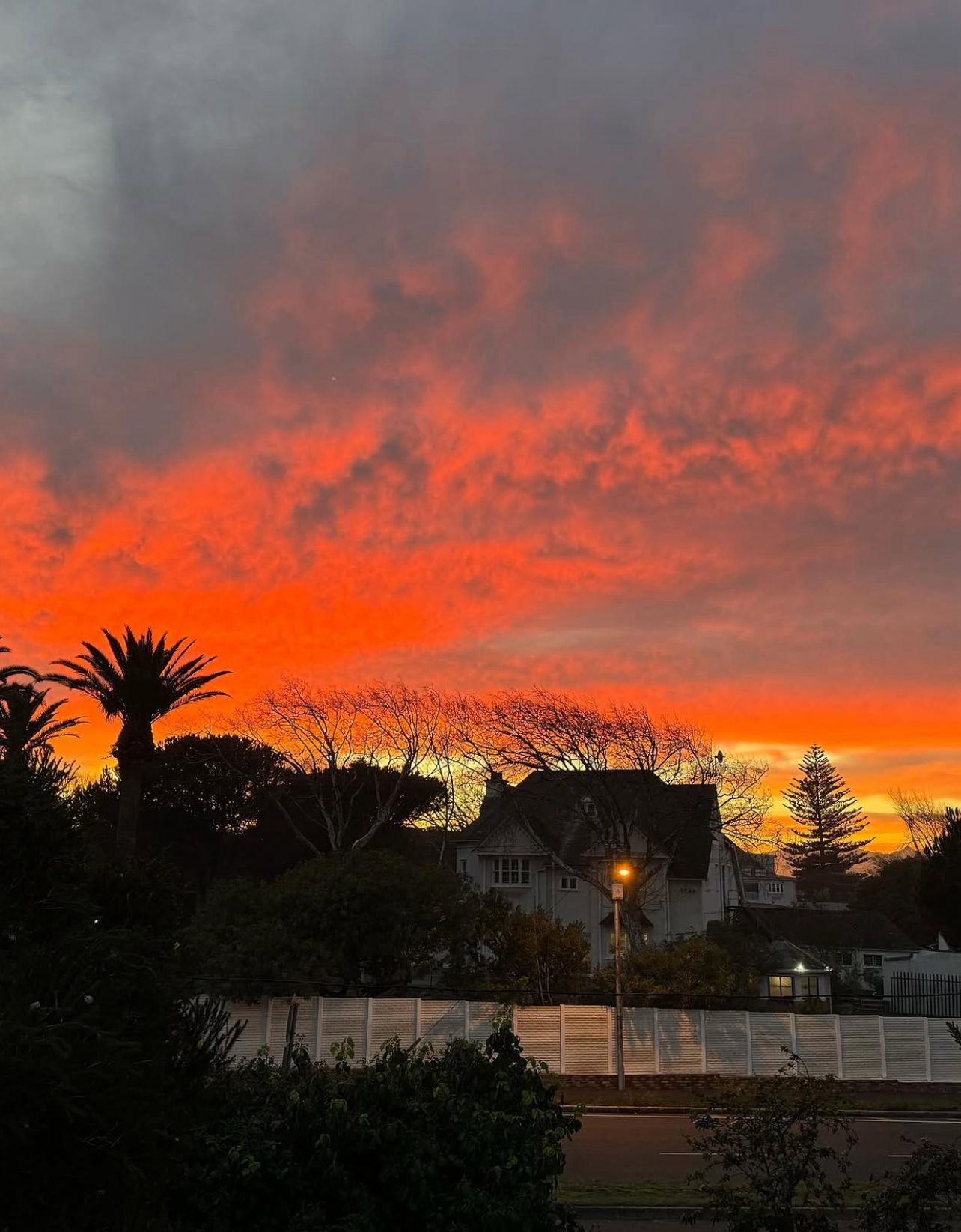 Crimson Cape Town sunset over the cottage rooftops